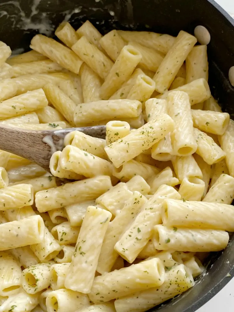 A rustic bowl of pasta e fagioli — Italian pasta and bean soup with vegetables, herbs, and a small pasta shape