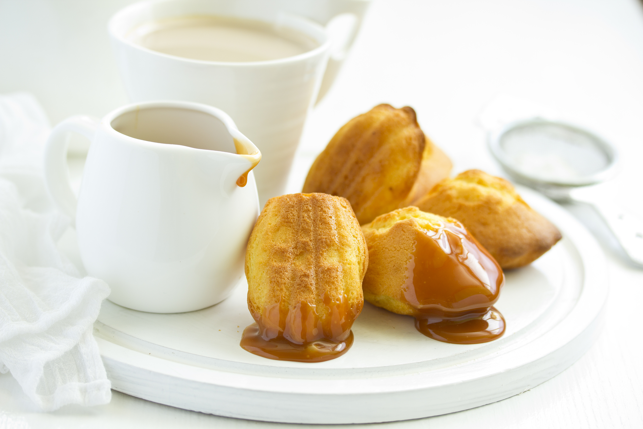 Classic French Madeleine Cookies Drizzled With Caramel Sauce