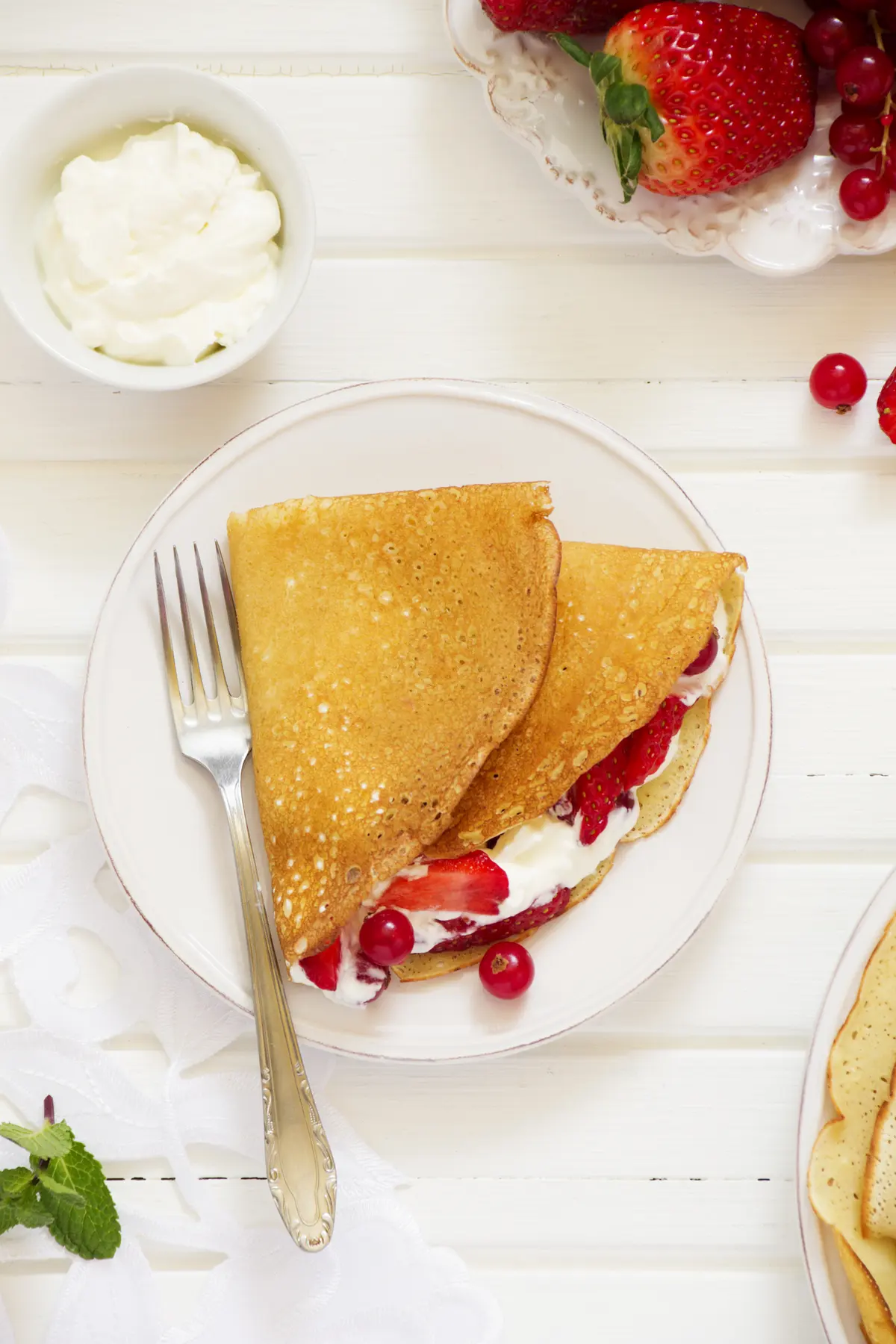 Fluffy Pancakes with Whipped Cream and Mixed Berries