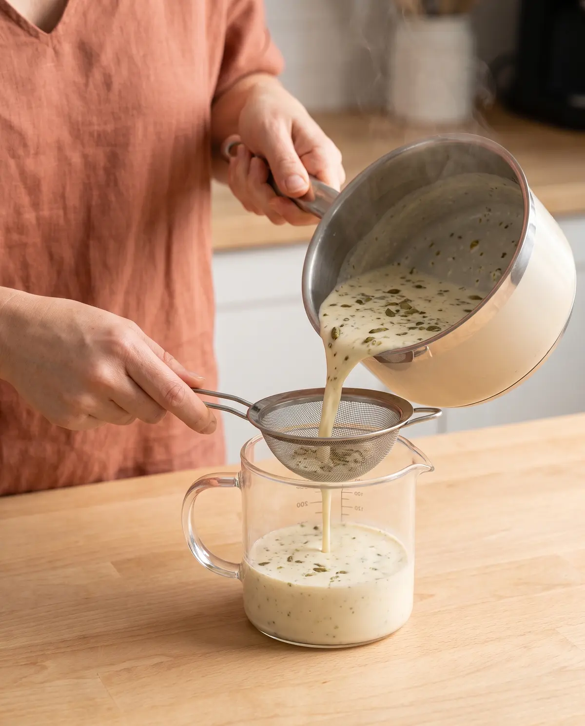 Straining cardamom-infused cream
