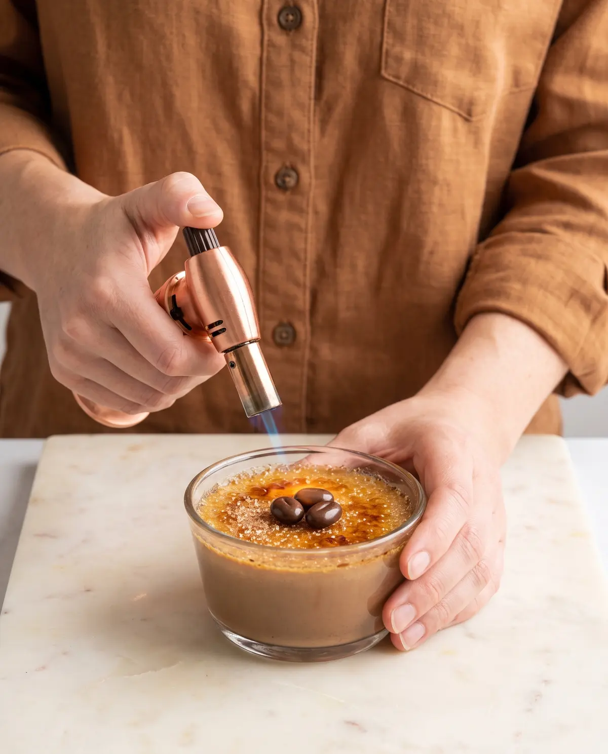 Feminine hands torching chocolate espresso crème brûlée