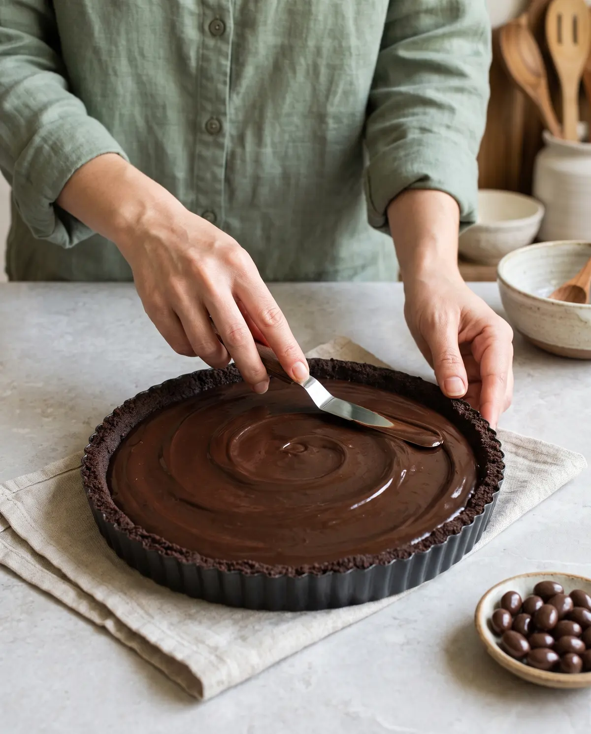 Smoothing chocolate espresso ganache into a pre-baked tart shell