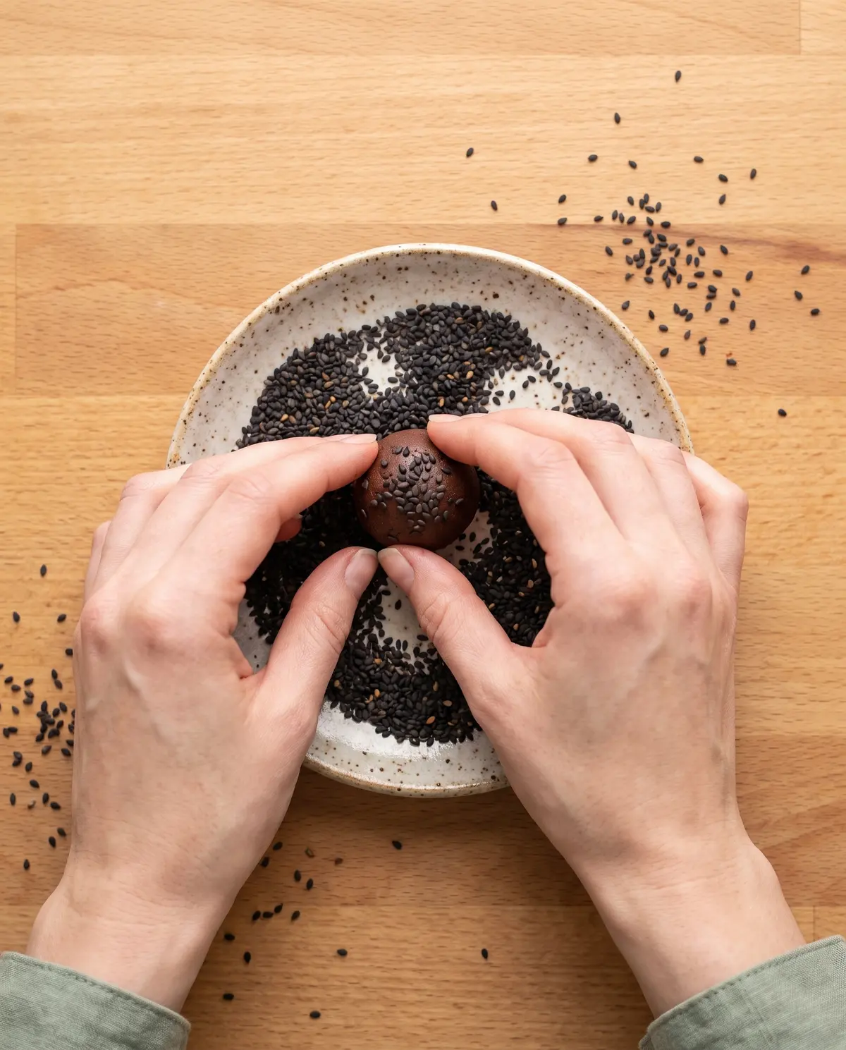 Rolling a black sesame truffle