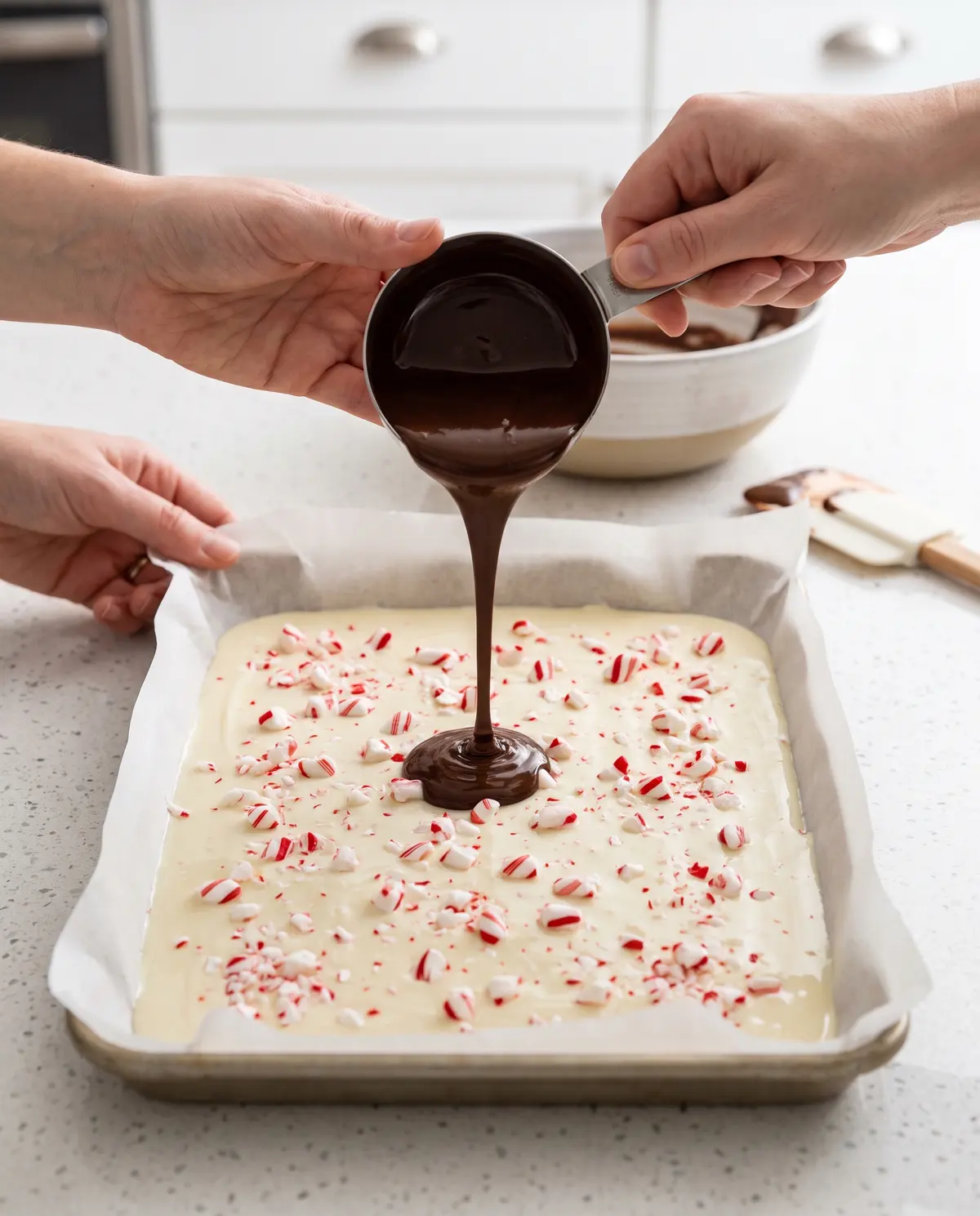 Making peppermint bark with hands pouring chocolate